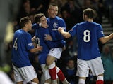 Rangers' Andy Little is congratulated by team mates after scoring his team's second goal on December 8, 2012