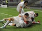 Galatasaray's Aydin Yilmaz is mobbed after scoring on Decemeber 5, 2012