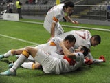 Galatasaray's Aydin Yilmaz is mobbed after scoring on Decemeber 5, 2012