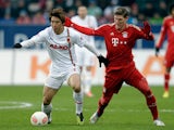 Augsburg's Koo Ja-cheol and Bayern Munich's Bastian Schweinsteiger battle for the ball on December 8, 2012