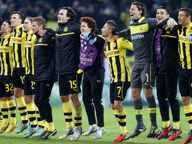 Dortmund squad members celebrate winning Champions League Group D on December 4, 2012