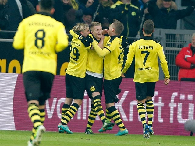 Borussia Dortmund's Marco Reus is congratulated by team mates after scoring the opener on December 8, 2012