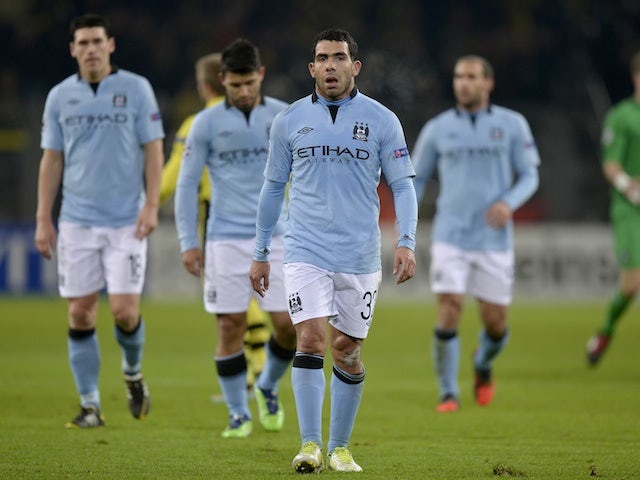 Manchester City players follow Carlos Tevez off the pitch after crashing out of Group D on December 4, 2012