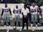 Cowboys players bow their heads in memory of killed teammate Jerry Brown, before their game with the Bengals on December 9, 2012