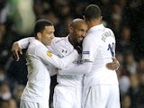 Tottenham Hotspur's Jermain Defoe is congratulated by team mate after scoring his team's third goal on December 6, 2012