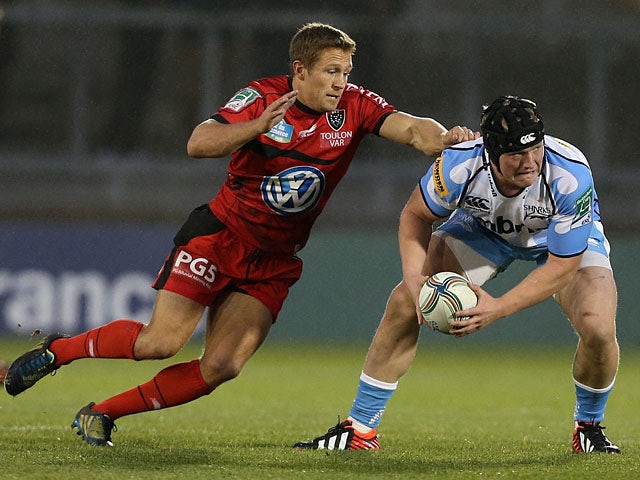 Toulon's Johnny Wilkinson attempts to hold back Sale's Ross Harrison on December 8, 2012