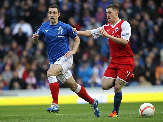 Rangers' Lee Wallace and Stirling's Ross McGeachie chase the ball on December 8, 2012