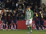 Lionel Messi celebrates with teammates after scoring his first against Betis on December 9, 2012