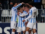 Malaga players celebrate their opening goal against Anderlecht on December 4, 2012