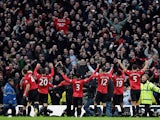 Manchester United players celebrate with fans after beating rivals Manchester City on December 9, 2012