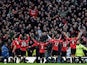Manchester United players celebrate with fans after beating rivals Manchester City on December 9, 2012
