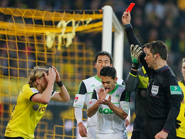 Borussia Dortmund's Marcel Schmelzer is shown a red card during the match against Wolfsburg on December 8, 2012