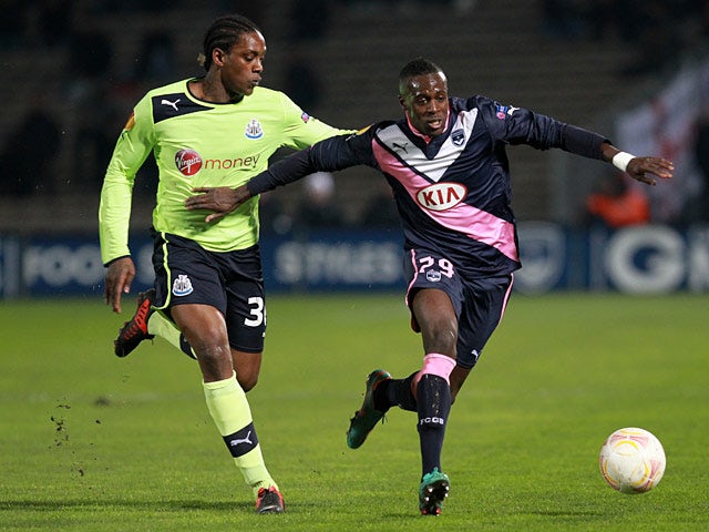 Bordeaux's Maxime holds up Newcastle's Nile Ranger on December 6, 2012