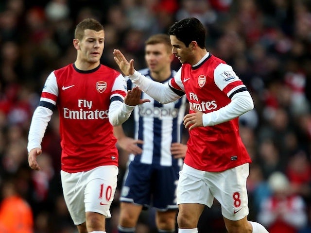 Mikel Arteta is congratulated by Jack Wilshere after his penalty on December 8, 2012