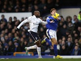 Nikica Jelavic and William Gallas battle for the ball on December 9, 2012