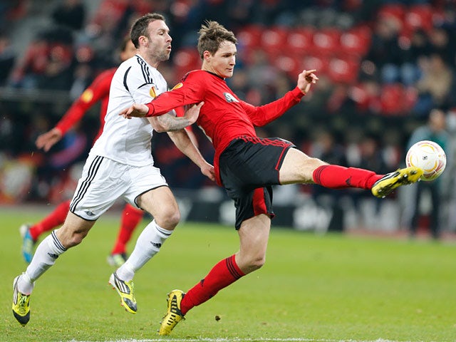 Rosenborg's Rade Prica and Leverkusen's Philipp Wollscheid battle for the ball on December 6, 2012