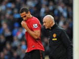 Rio Ferdinand receives medical treatment to his cut head on December 9, 2012