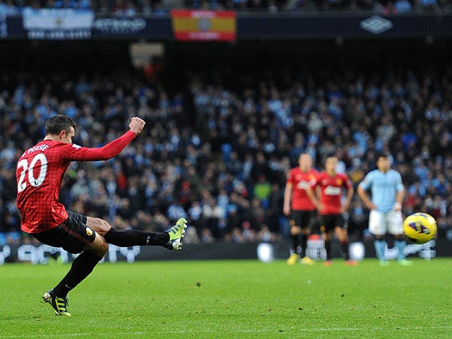 Robin Van Persie strikes the ball to score the winner against rivals Manchester City on December 9, 2012