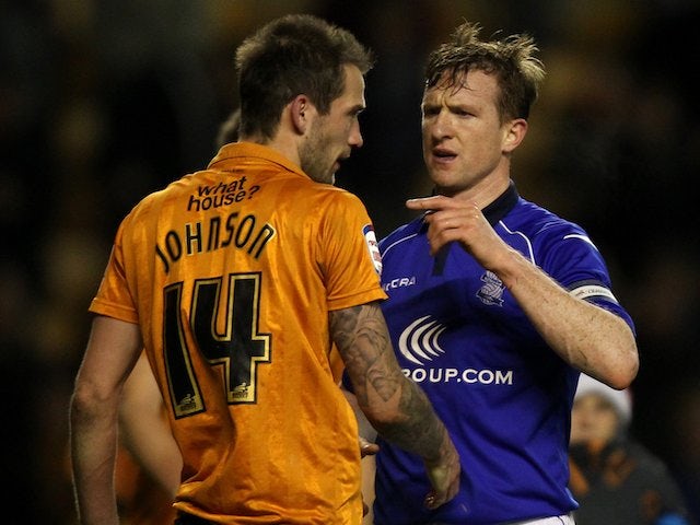 Birmingham's Steven Caldwell and Wolves defender Roger Johnson have words at the end of the match on December 8, 2012