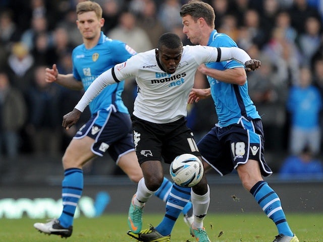 Derby's Theo Robinson battles with Leeds midfielder Michael Tonge on December 8, 2012