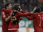 Bayern Munich's Thomas Mueller is congratulated by his team mates after scoring the opener on December 8, 2012