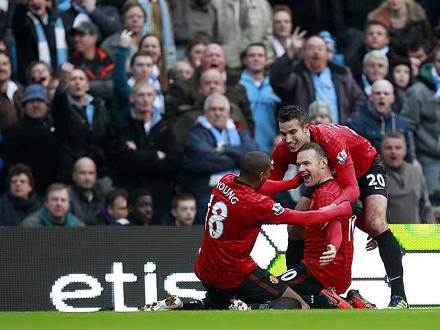 Wayne Rooney celebrates his goal with team mates Ashley Young and Robin Van Persie on December 9, 2012