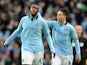 Yaya Toure is congratulated by Samir Nasri after scoring his team's first goal on December 9, 2012