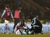 Aston Villa striker Darren Bent is treated for injury at Carrow Road on December 11, 2012