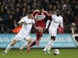 Middlesbrough's Emmanuel Ledesma battles for possession with two Swansea players on December 12, 2012