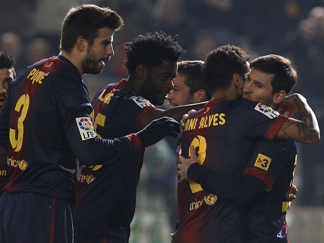 Messi is congratulated by teammates after his early Copa Del Rey strike against Cordoba on December 12, 2012