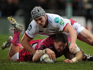 Exeter Chiefs' Simon Alcott beats Scarlets' Jonathan Davies to score his team's second try on December 15, 2012