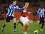 Barnsley's Tomasz Cywka and Sheffield Wednesday's Chris Lines battle for the ball on December 15, 2012