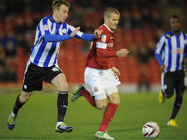Barnsley's Tomasz Cywka and Sheffield Wednesday's Chris Lines battle for the ball on December 15, 2012