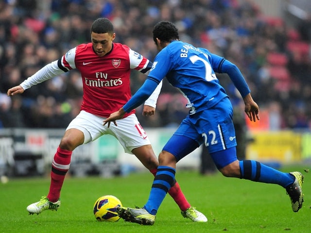 Arsenal's Alex Oxlade-Chamberlain and Wigan Athletic's Jean Beausejour on December 22, 2012