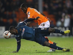 Blackpool's Isaiah Osbourne challenges Wolves' Sylvain Ebanks-Blake for the ball on December 21, 2012