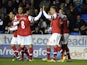 Arsenal players congratulate Lukas Podolski after he opened the scoring against Reading on December 17, 2012