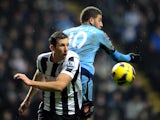 Mike Williamson and Adel Taarabt in action on December 22, 2012