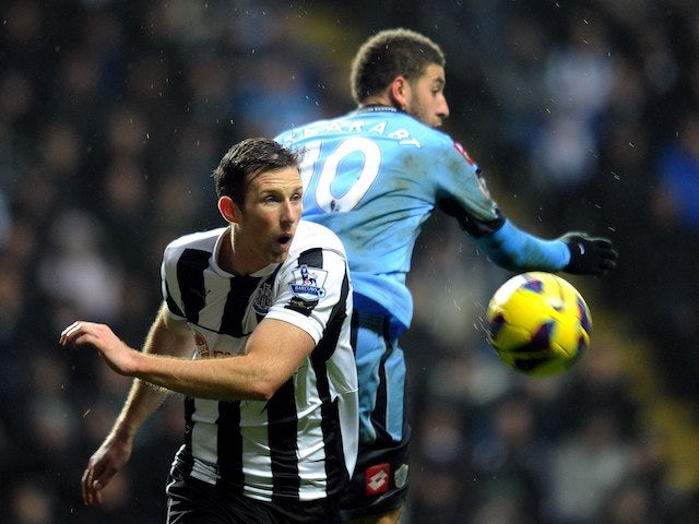 Mike Williamson and Adel Taarabt in action on December 22, 2012