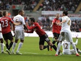 United's Van Persie reacts angrily to a challenge by Ashley Williams of Swansea on December 23, 2012