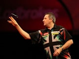 Ronnie Baxter in action against Dennis Priestley at the Ladbrokes.com World Darts Championships on December 19, 2012