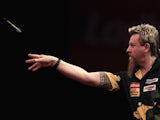 Simon Whitlock throwing during his second round match in the World Darts Championship on December 22, 2012