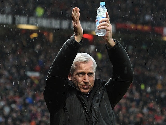 Newcastle boss Alan Pardew applauds the travelling Magpies fans at Old Trafford on December 26, 2012