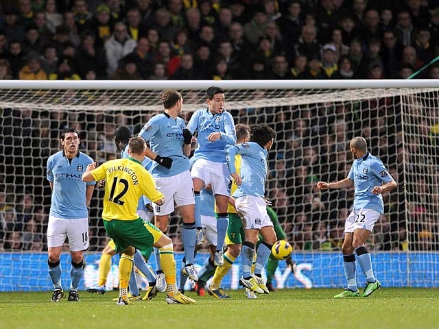 Anthony Pilkington takes a free kick to score his team's first goal against Manchester City on December 29, 2012