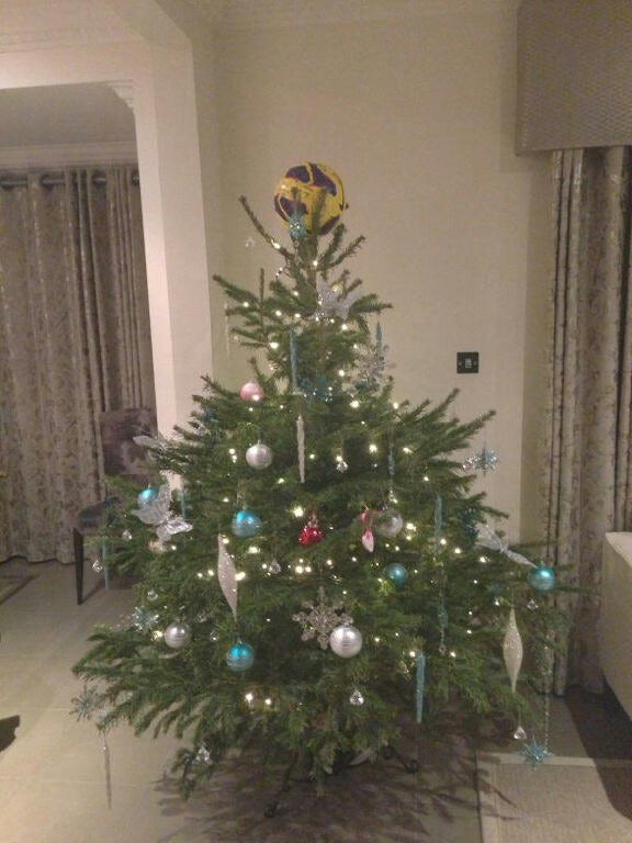 After scoring three goals at Aston Villa, Gareth Bale puts his  matchball on top of his Christmas tree