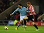 City striker Carlos Tevez is challenged by Sunderland's Jack Colback during their game on December 26, 2012