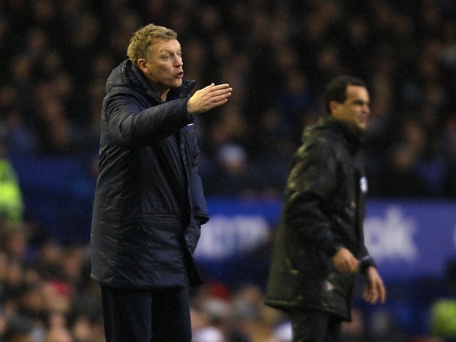 Everton manager David Moyes instructs his players on the touchline whilst Wigan's Roberto Martinez does the same next to him on December 26, 2012