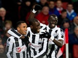 Demba Ba celebrates with team mates after scoring his first against Arsenal on December 29, 2012