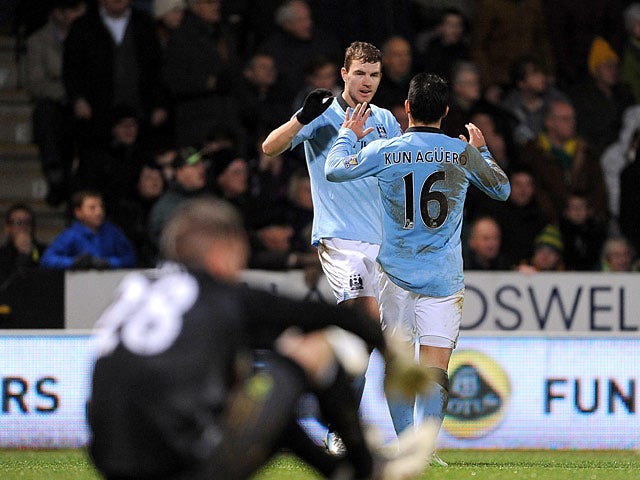 Sergio Aguero and Edin Dzeko celebrate their team's fourth goal against Norwich City on December 29, 2012