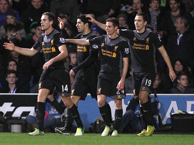 Luis Suarez celebrates his goal with team mates against QPR on December 30, 2012