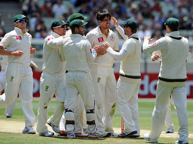 Australia's Mitchell Johnson is congratulated by his team after bowling out Sri Lanka's Angleo Mathews on December 28, 2012